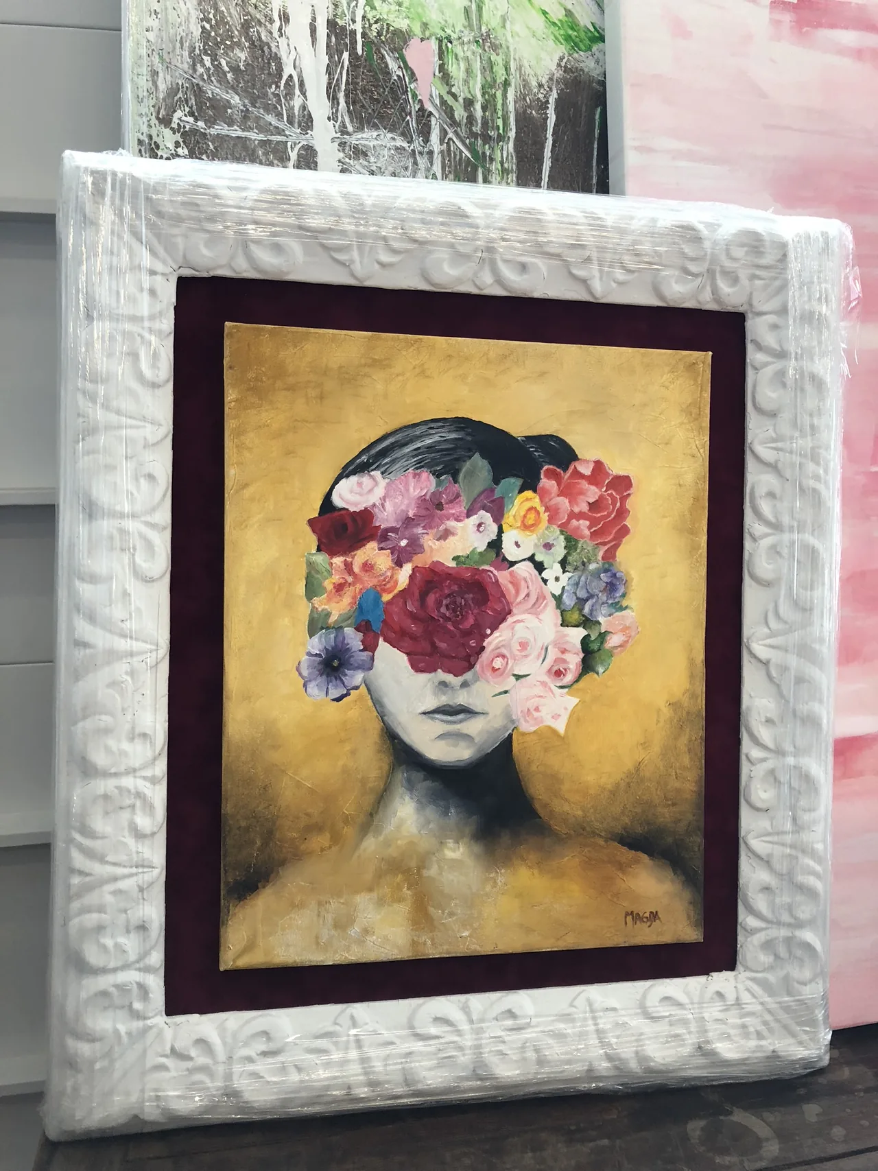 A colorful portrait in an ornate custom frame