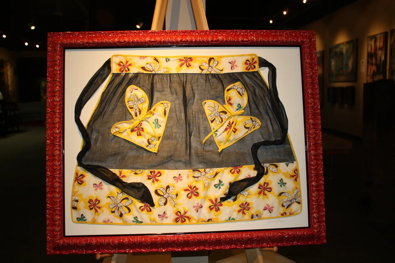 Framed textile in a red and black frame