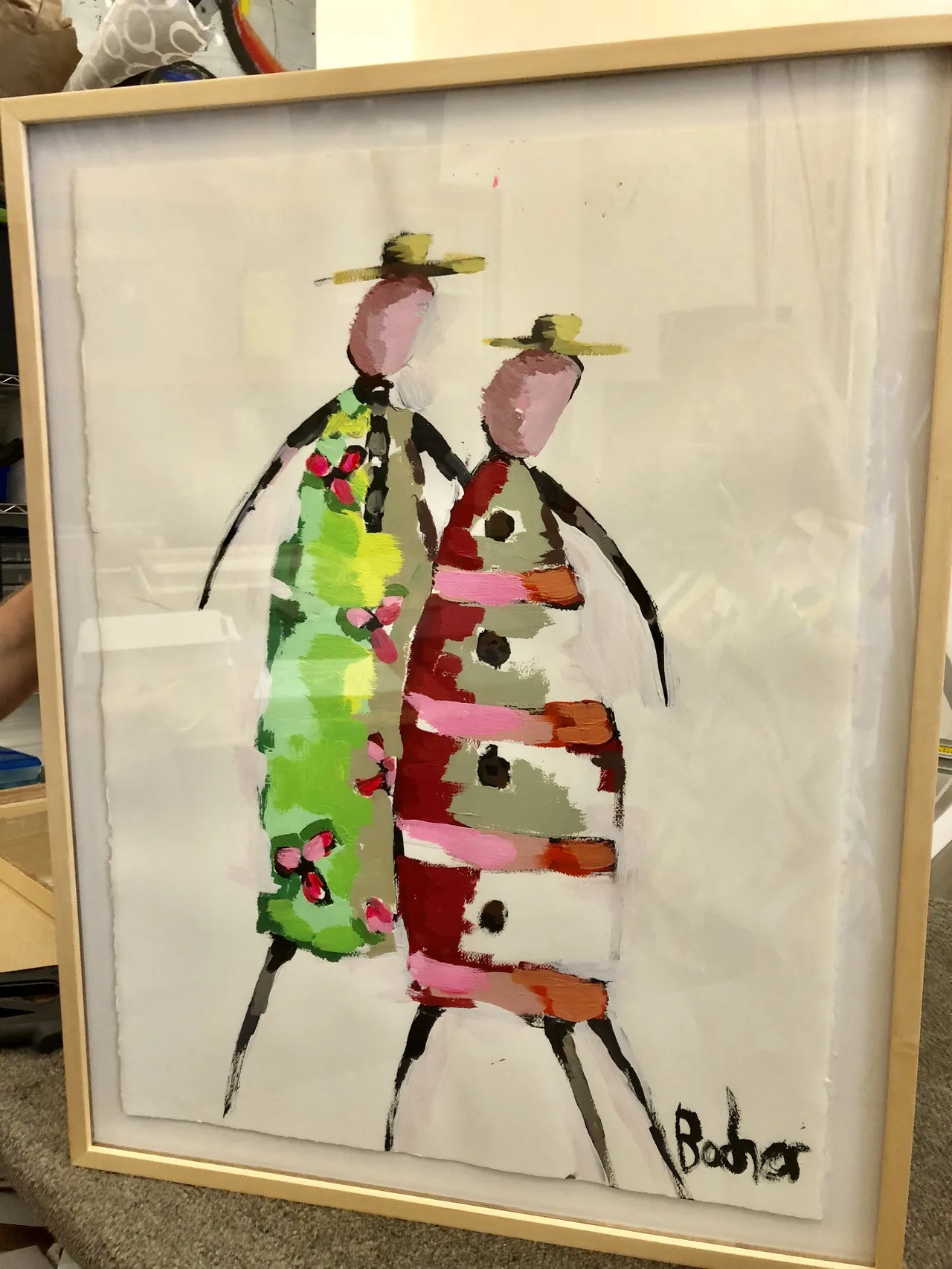 Framed textile figures in a shadow box