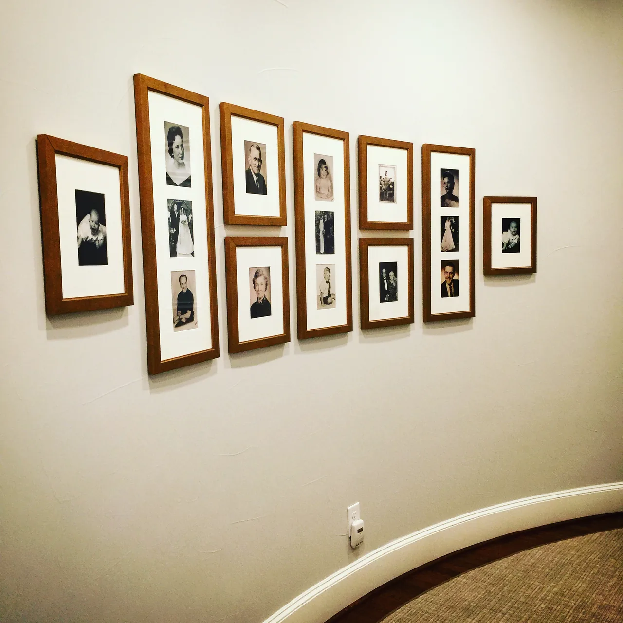 A salon wall of black and white photographs