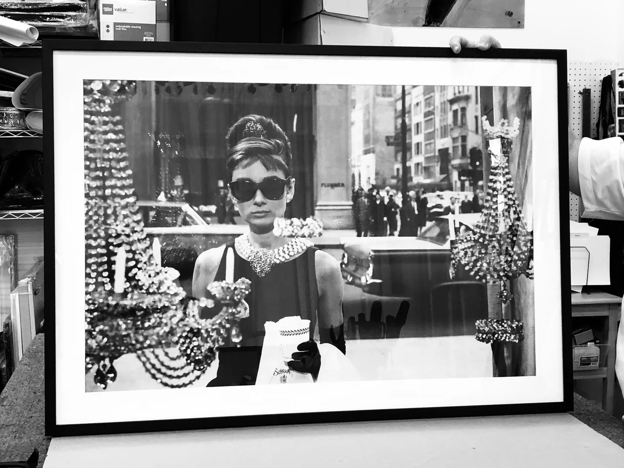 Black and white portrait photograph in a black frame